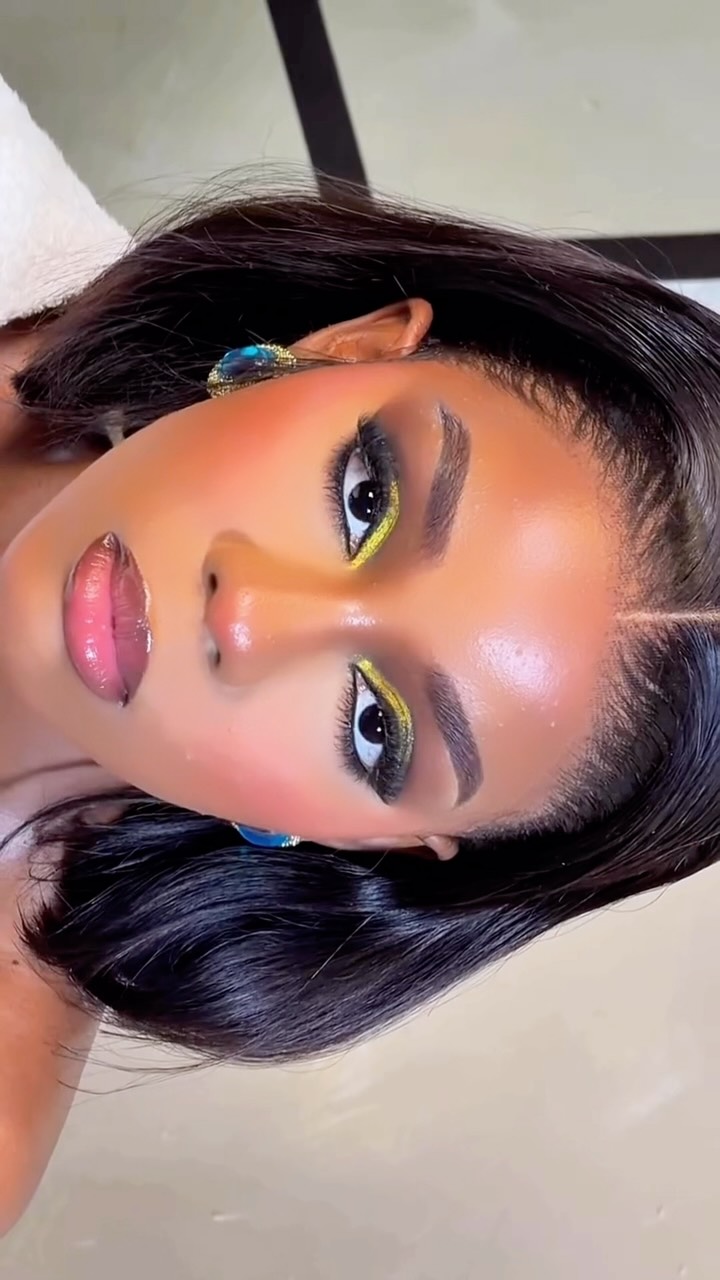 Close-up beauty portrait of Angel with gold liner and a blue hair jewel